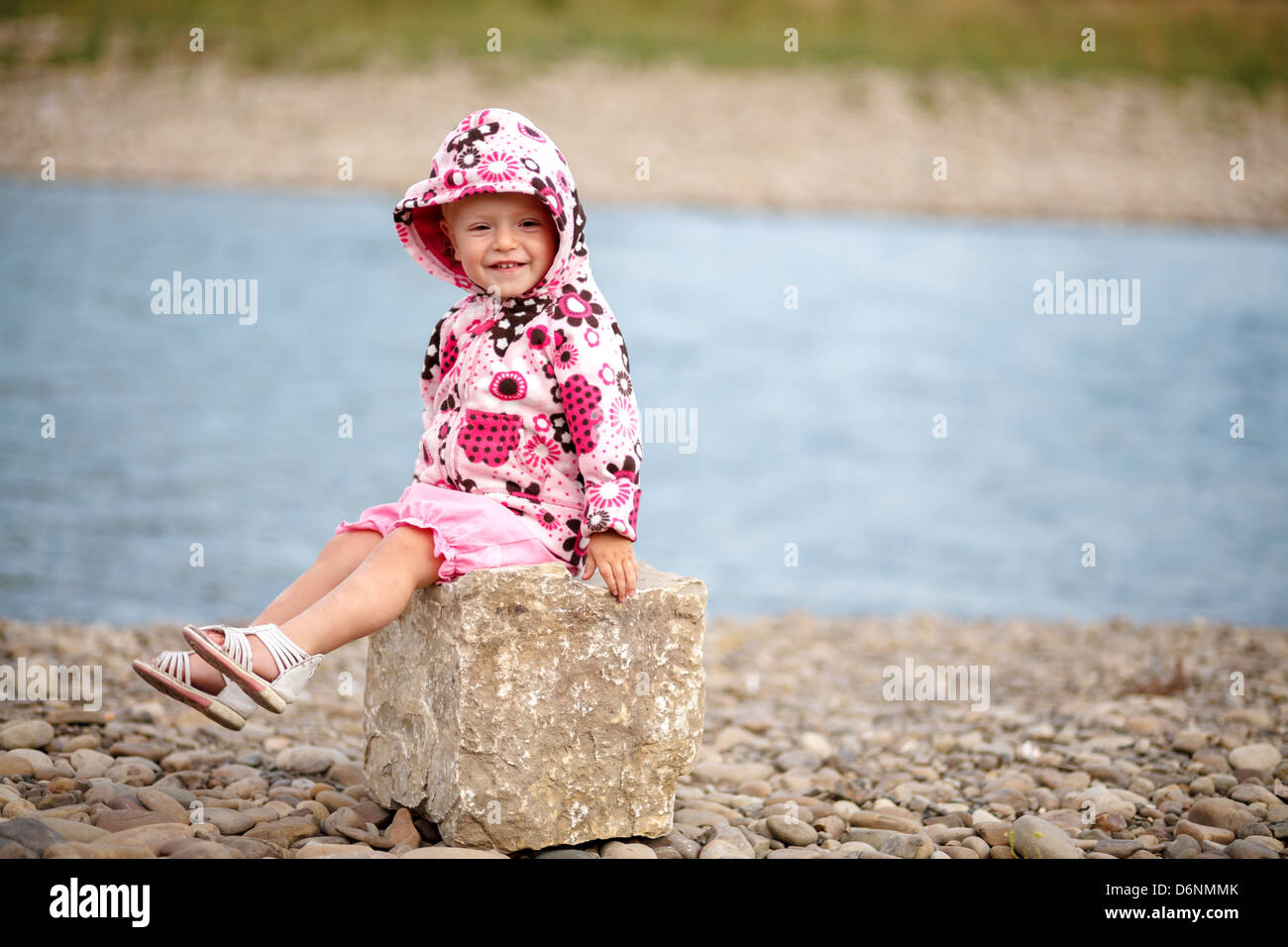 little girl playing near river Stock Photo - Alamy