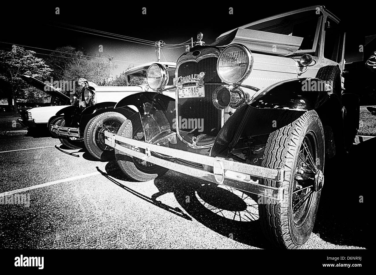 Grainy black and white image of antique cars at car show. Stock Photo