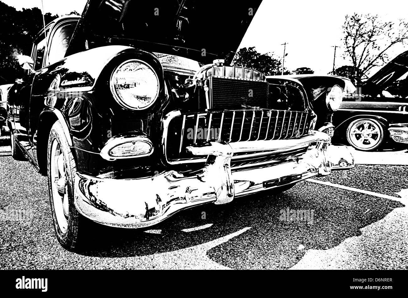 Black and white closeup of front of antique Chevy car at car show. Stock Photo