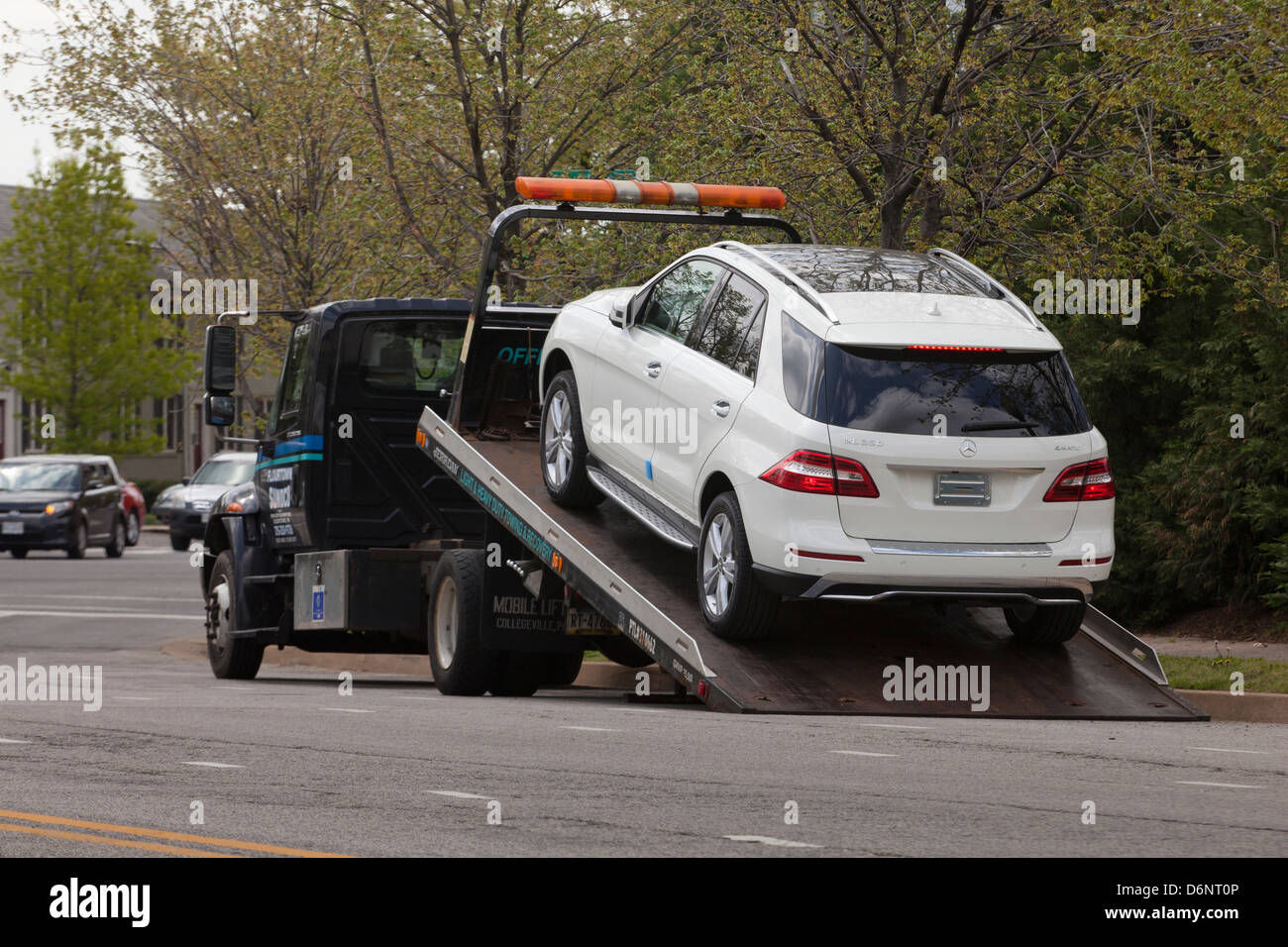 Flatbed tow truck loading an SUV - USA Stock Photo