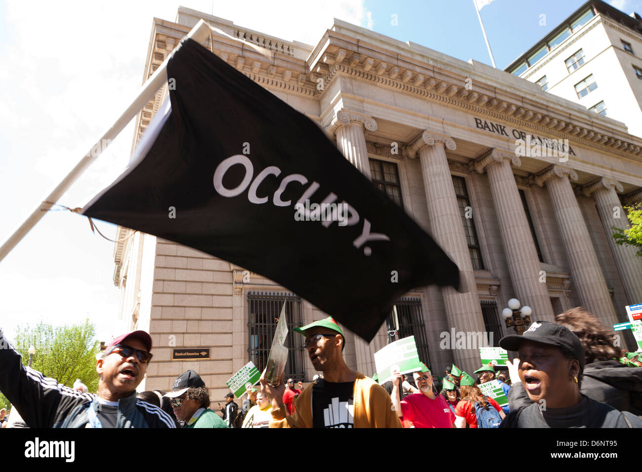 Man waving an OCCUPY flag at a rally in front of the Bank Of America building, Washington DC Stock Photo