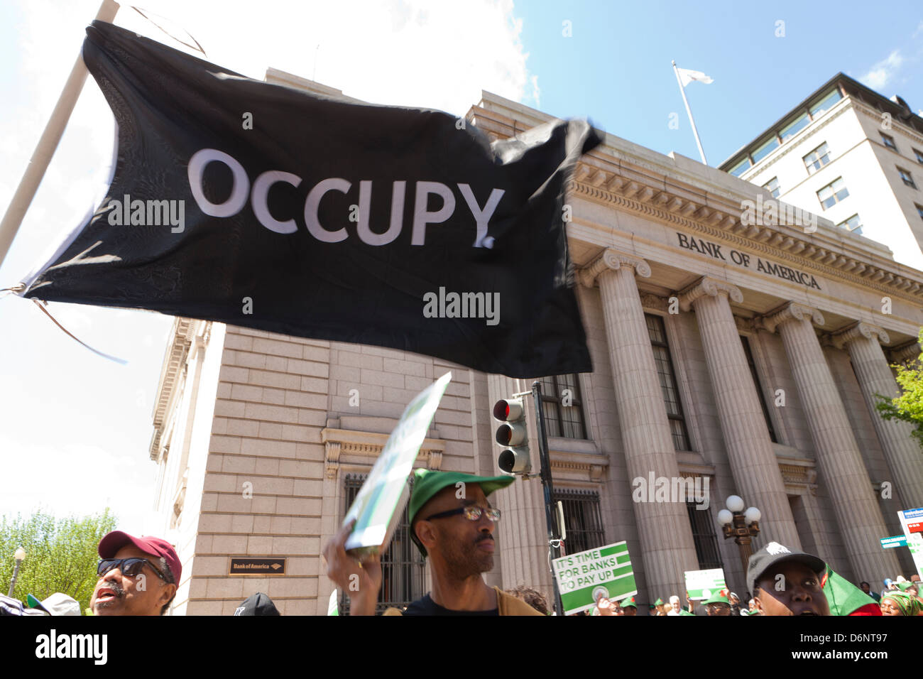 Man waving an OCCUPY flag at a rally in front of the Bank Of America building, Washington DC Stock Photo