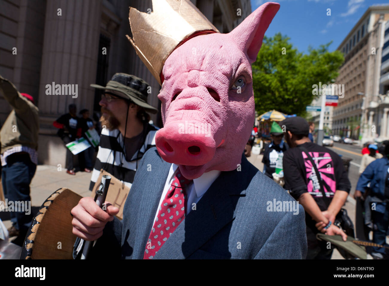 Man wearing a pig mask in rally Stock Photo