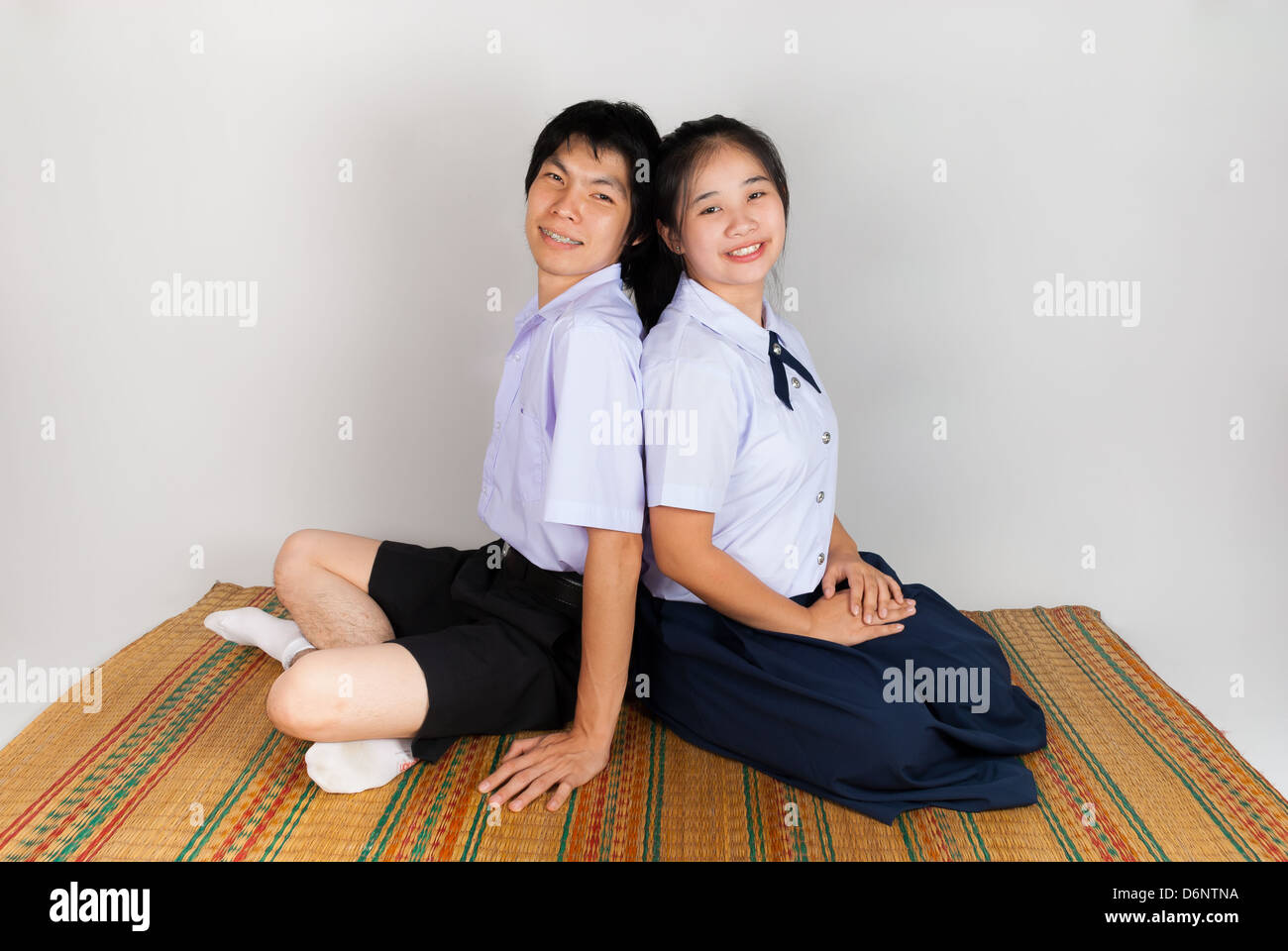 Lovers of High School Asian Thai Students are sitting together Stock Photo