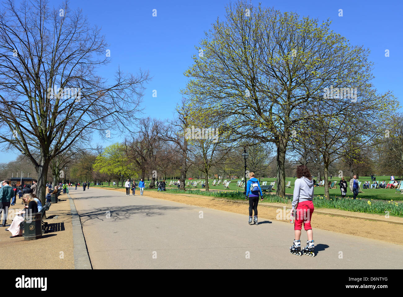 Girls rollerblading on path by The Serpentine, Hyde Park, City of Westminster, London, England, United Kingdom Stock Photo