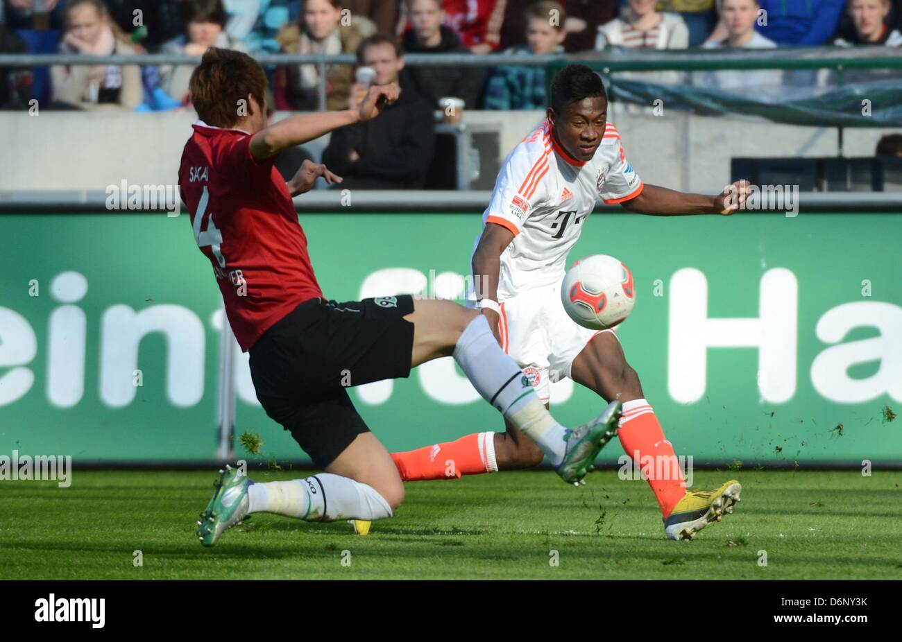 Hanover's Hiroki Sakai (L) vies for the ball with Munich's David Alaba during the Bundesliga soccer match between Hanover 96 and FC Bayern Munich at AWD Arena in Hanover, Germany, 20 April 2013. Munich won the match 1-6. Photo: Julian Stratenschulte Stock Photo