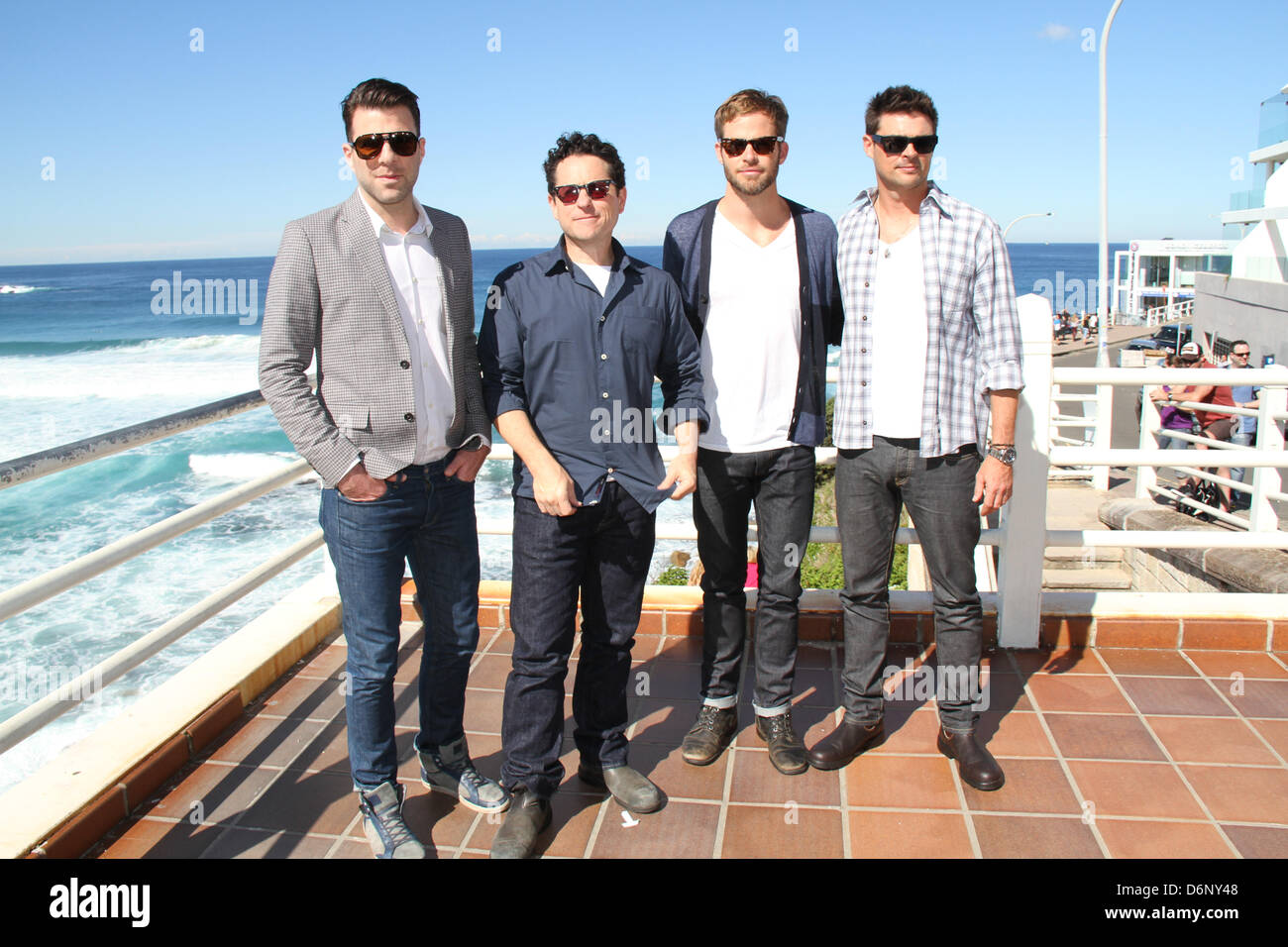 Bondi Beach, Sydney, NSW, Australia. 22 April 2013. Director J.J. Abrams and actors Chris Pine, Zachary Quinto and Karl Urban pictured at Bondi Beach for a photocall ahead of the Star Trek Into Darkness red carpet Australian and World Premiere. Lifeguard Deano from Bondi Rescue joined them. Credit: Credit:  Richard Milnes / Alamy Live News. Stock Photo