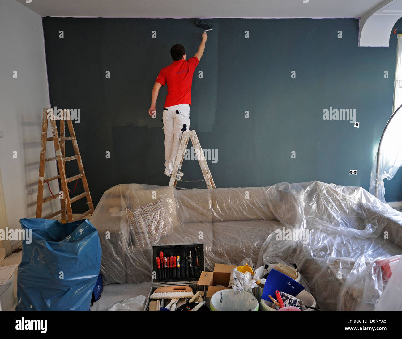 Professional painter during his work. Stock Photo
