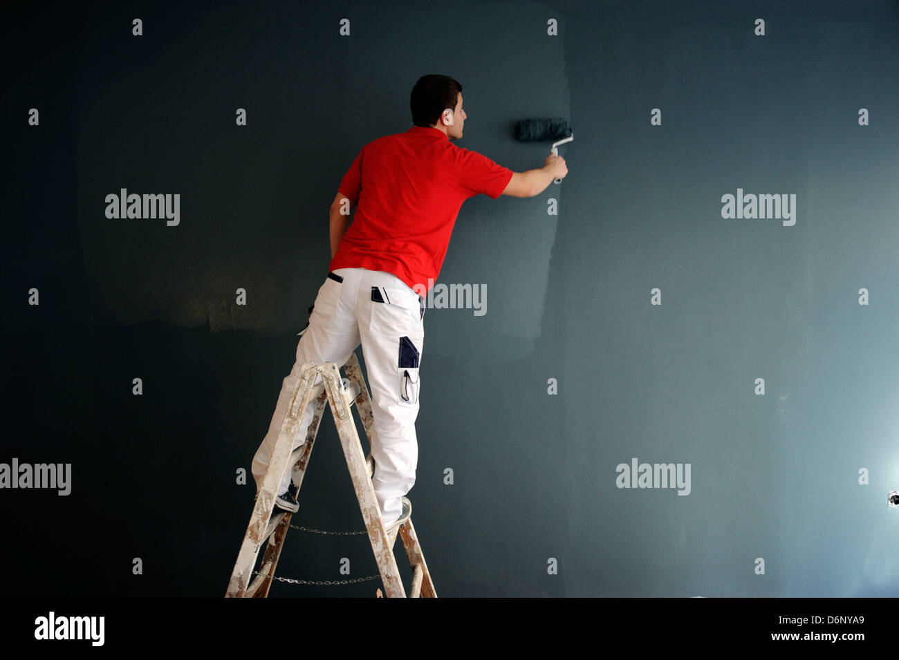 Professional painter during his work. Stock Photo