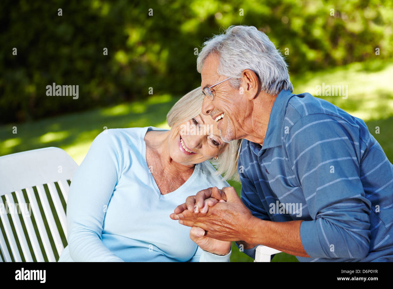 Happy senior couple in love sitting outside in a garden Stock Photo - Alamy