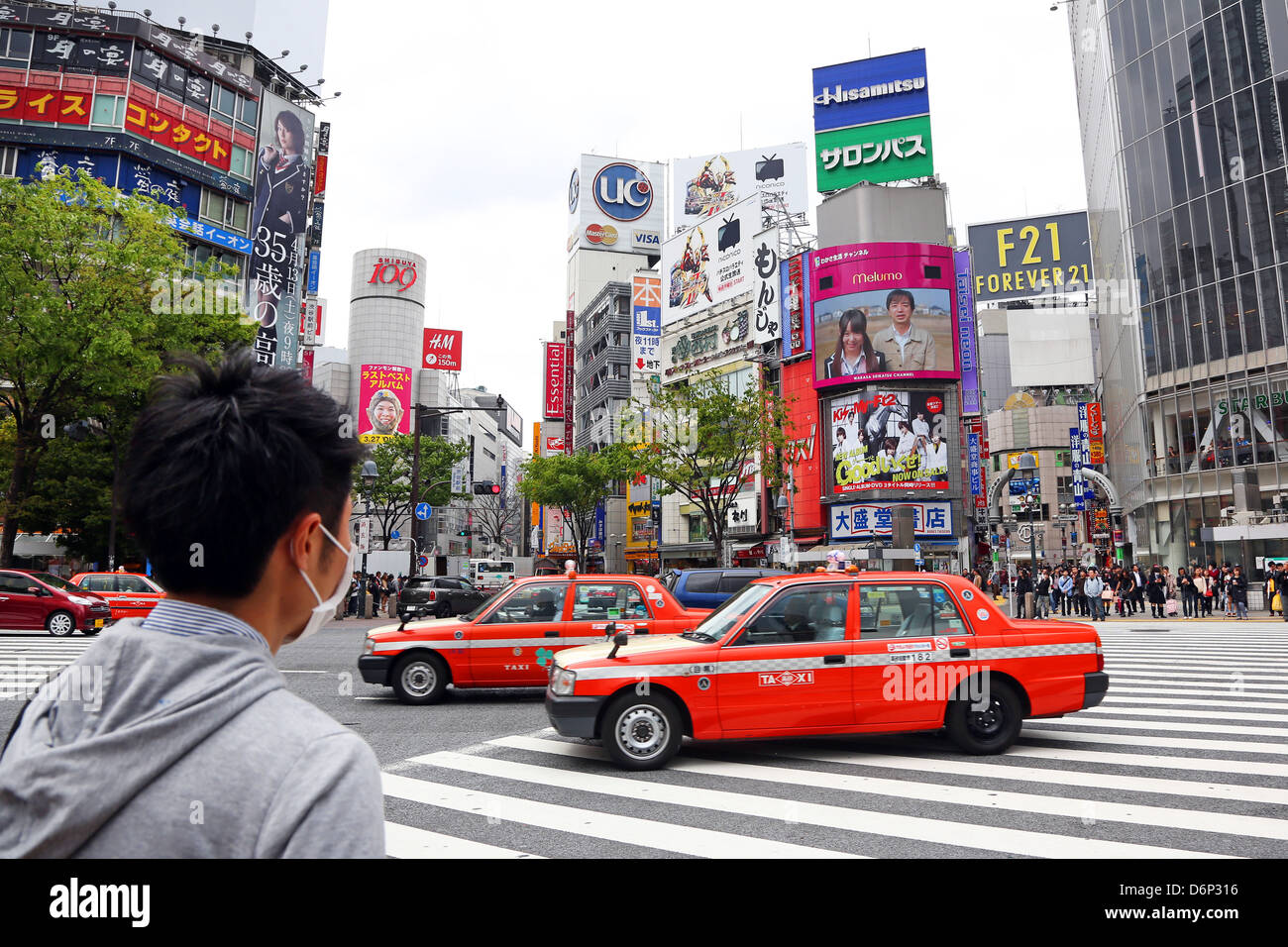 Pedestrian crossing and street scene with Japanese taxi cabs in Shibuya, Tokyo, Japan Stock Photo