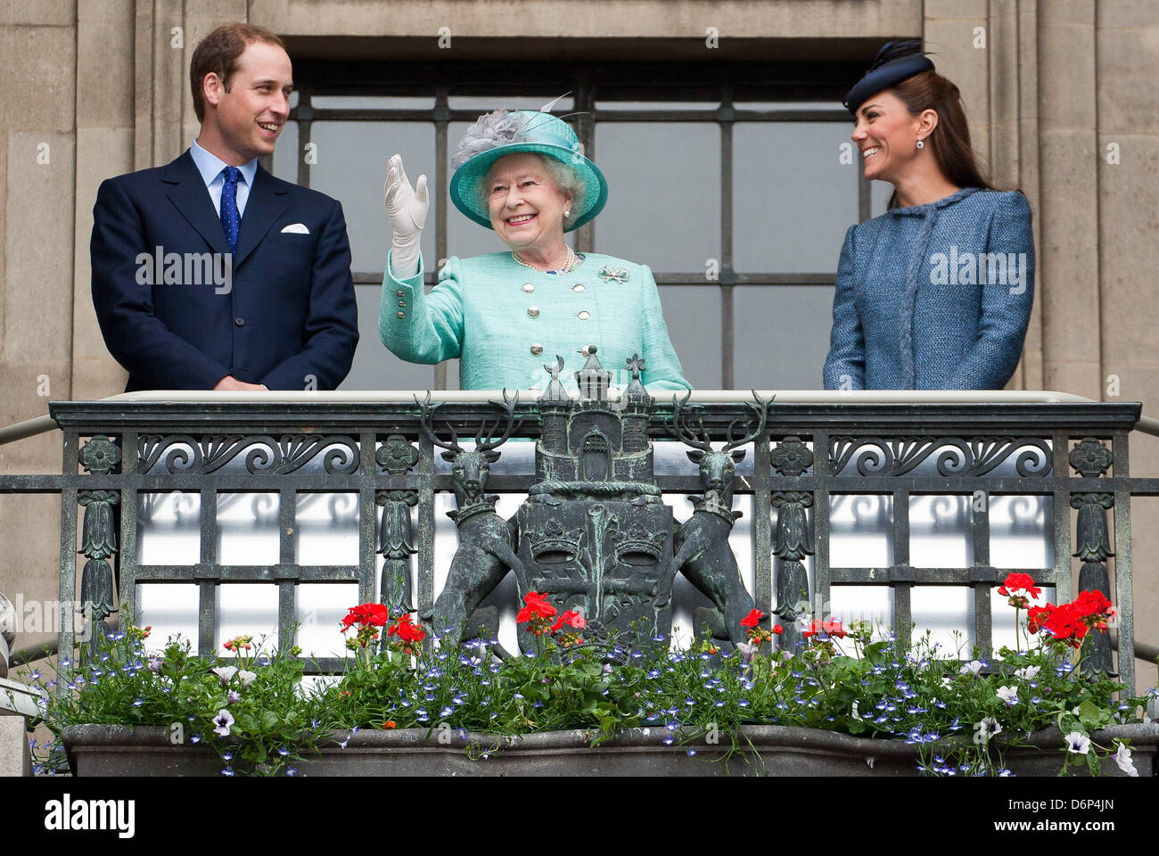 Britain's Queen Elizabeth is joined on Nottingham's Town Hall balcony by Prince William and Catherine. Stock Photo