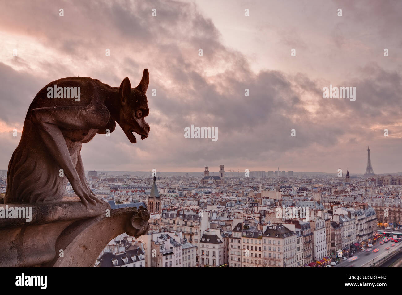 A gargoyle on Notre Dame de Paris cathedral looks over the city, Paris, France, Europe Stock Photo