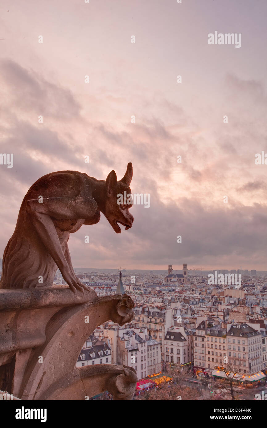 A gargoyle on Notre Dame de Paris cathedral looks over the city, Paris, France, Europe Stock Photo