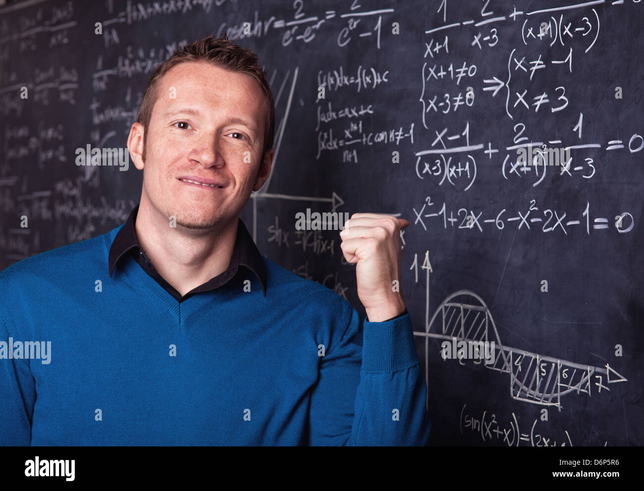 young caucasian teacher portrait with blackboard background Stock Photo