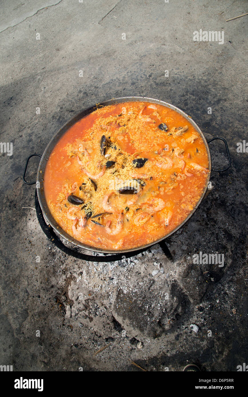 Spanish Paella cooking in a pan on hot embers Stock Photo Alamy