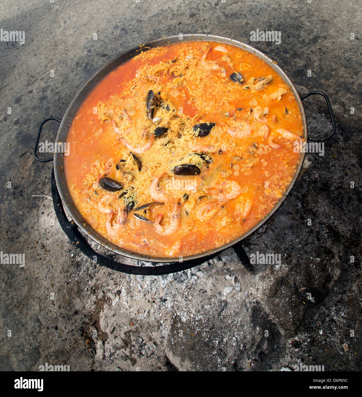 Spanish Paella cooking in a pan on hot embers Stock Photo Alamy