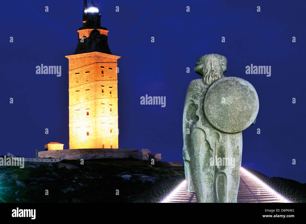 Spain, Galicia: Hercules tower and sculpture of Celtic warrior Bréogan in A Coruna at night Stock Photo