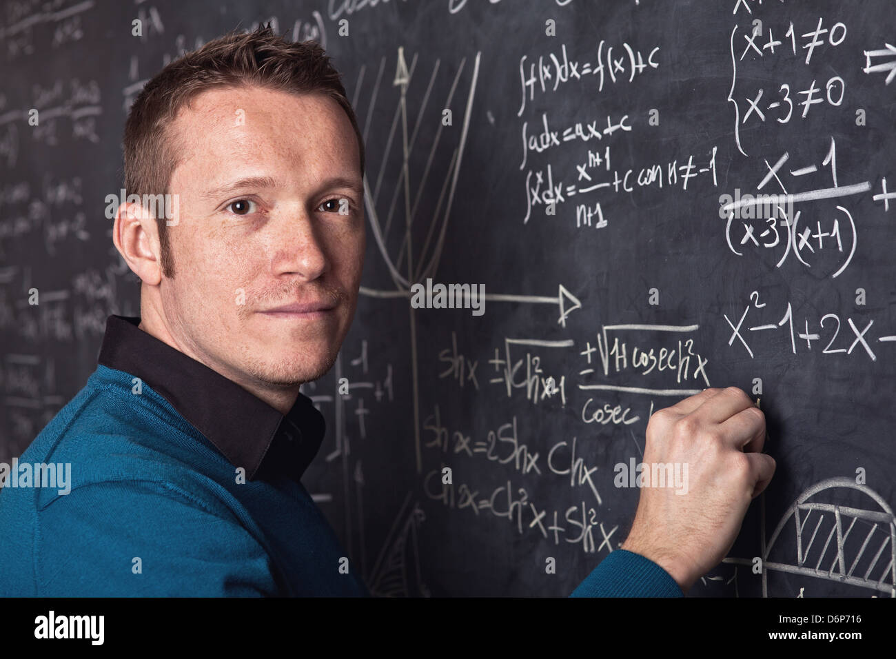 young caucasian teacher portrait with blackboard background Stock Photo