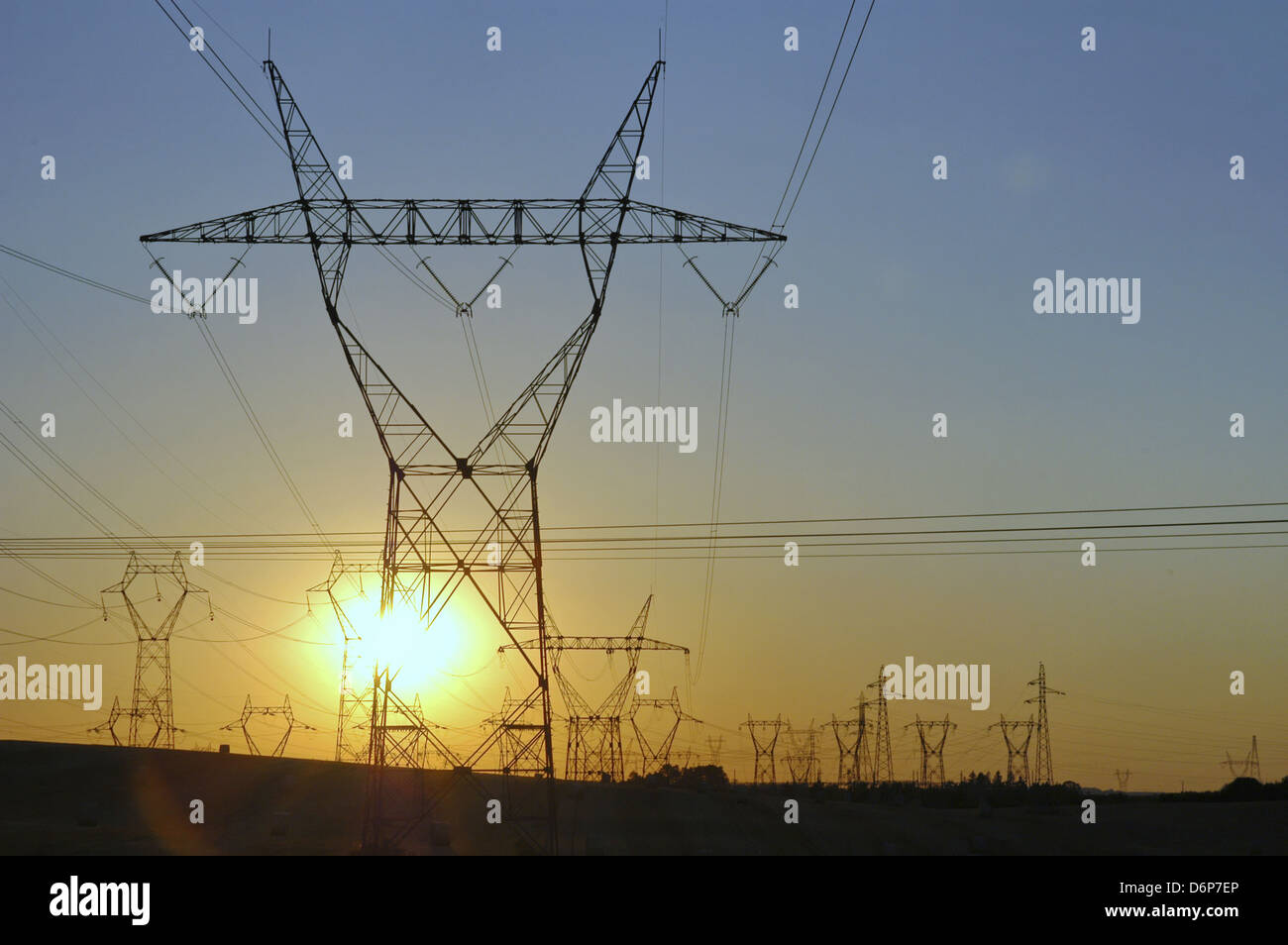 France, Burgundy, high voltage lines, Sunset peaceful, harmonious, high voltage pylons on the field, power lines, transmission Stock Photo