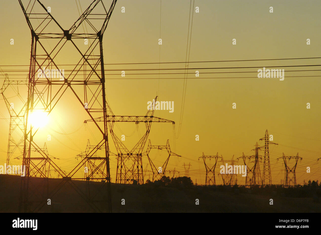 France, Burgundy, high voltage lines, Sunset peaceful, harmonious, high voltage pylons on the field, power lines, transmission Stock Photo