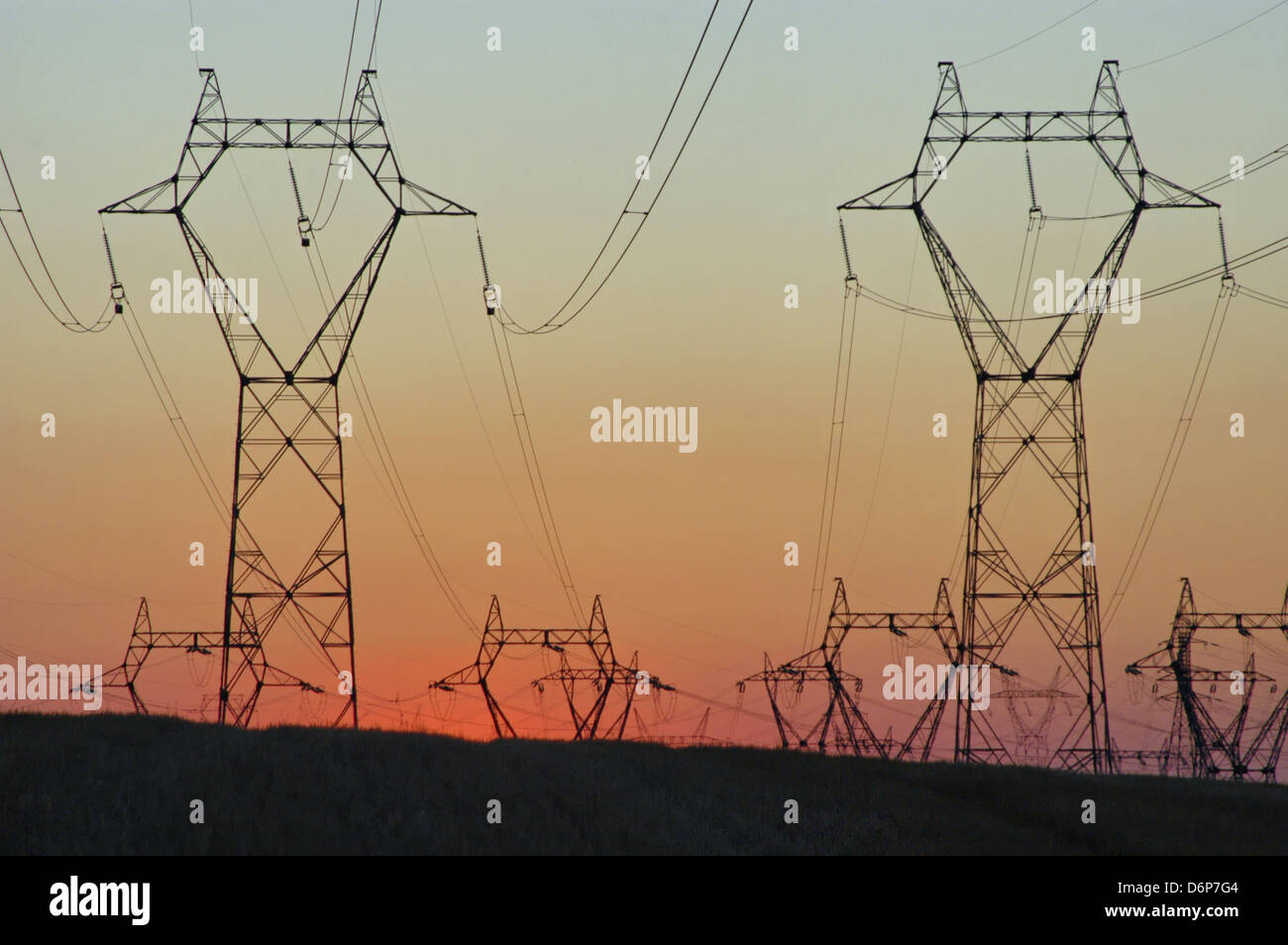 France, Burgundy, high voltage lines, Sunset peaceful, harmonious, high voltage pylons on the field, power lines, transmission Stock Photo