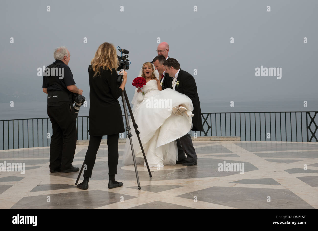 Photographing the bride and groom. Wedding party in Nerja, Southern Spain  photographer video and stills cameraman Stock Photo - Alamy