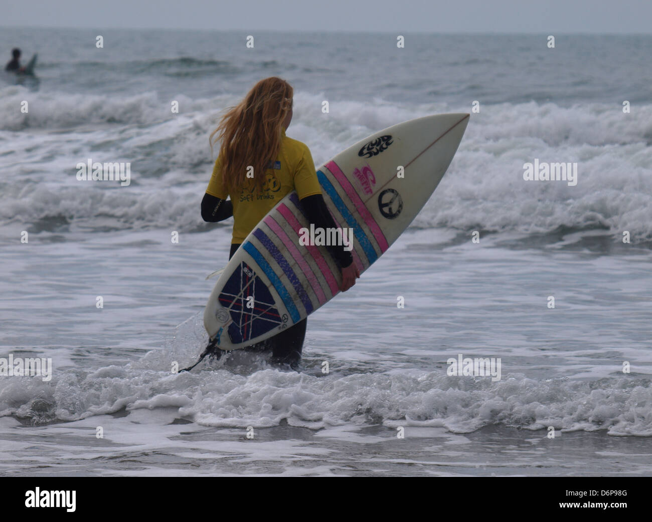 Female teenage surfer, Cornwall, UK 2013 Stock Photo