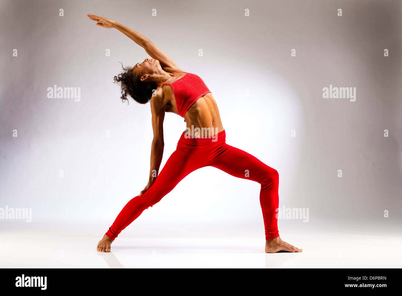 Studio shot of exercising woman Stock Photo
