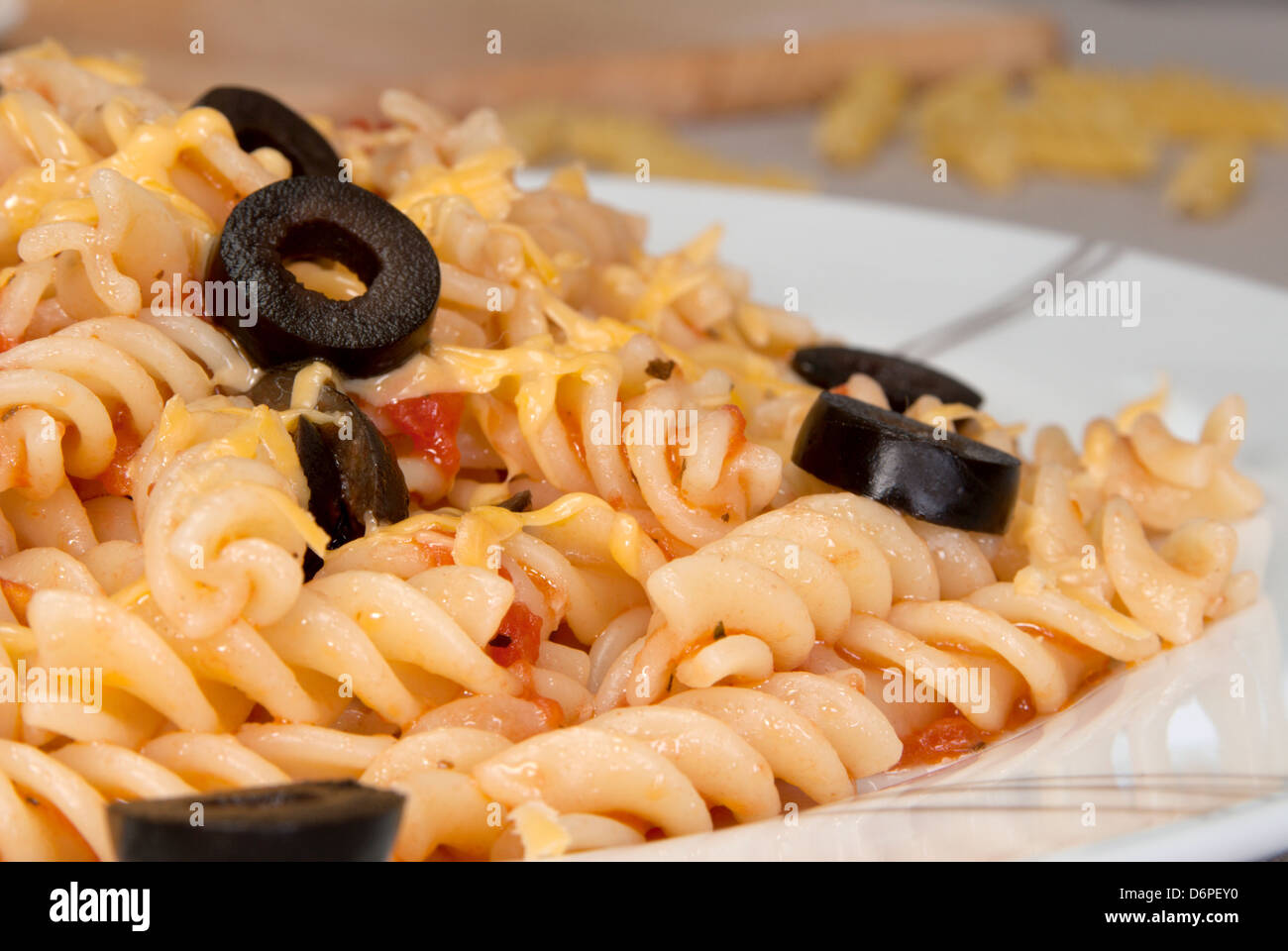Pasta with tomato, garlic and black olives Stock Photo