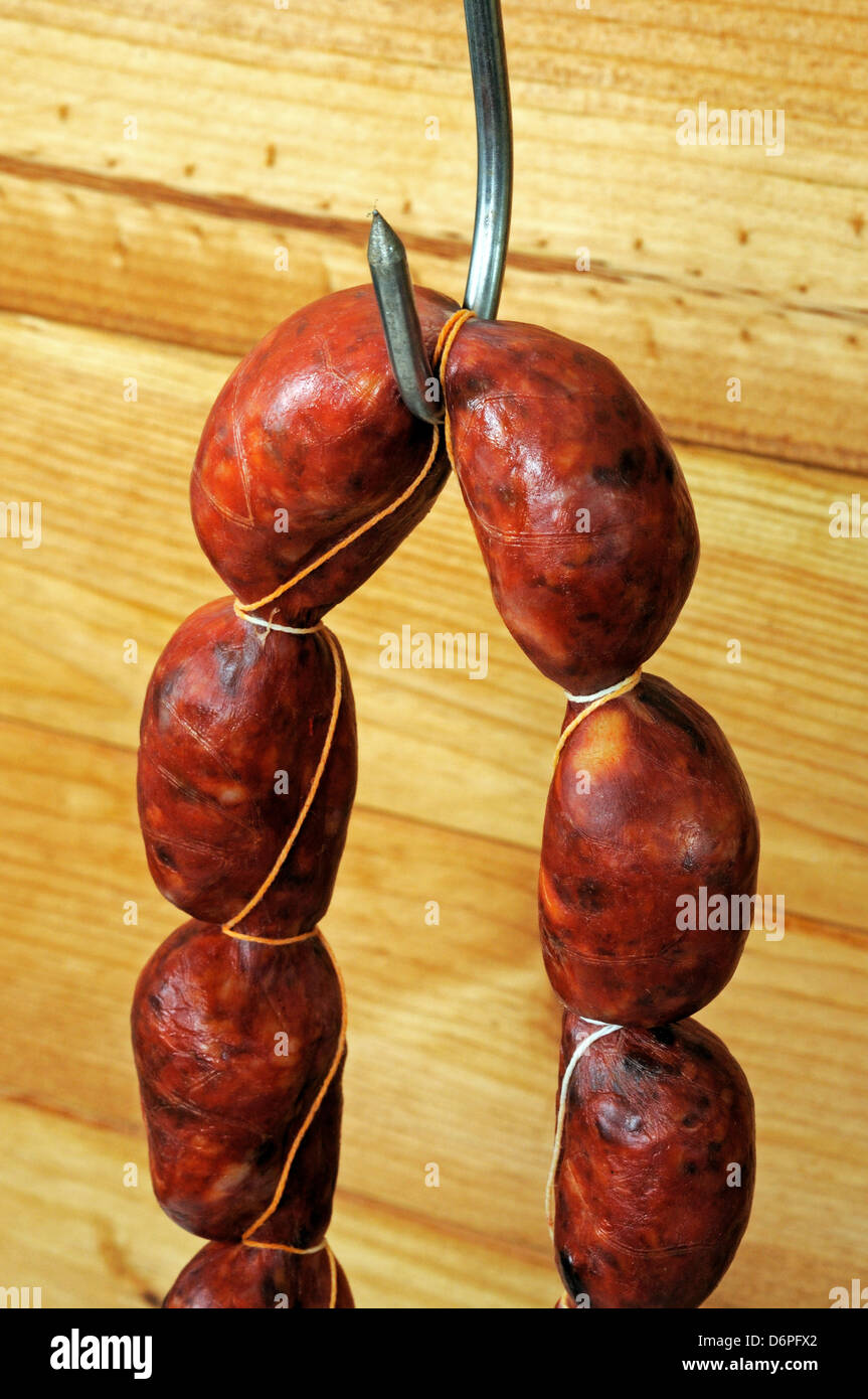 String of Spanish Chorizo sausage hanging from a meat hook, Spain, Western Europe. Stock Photo