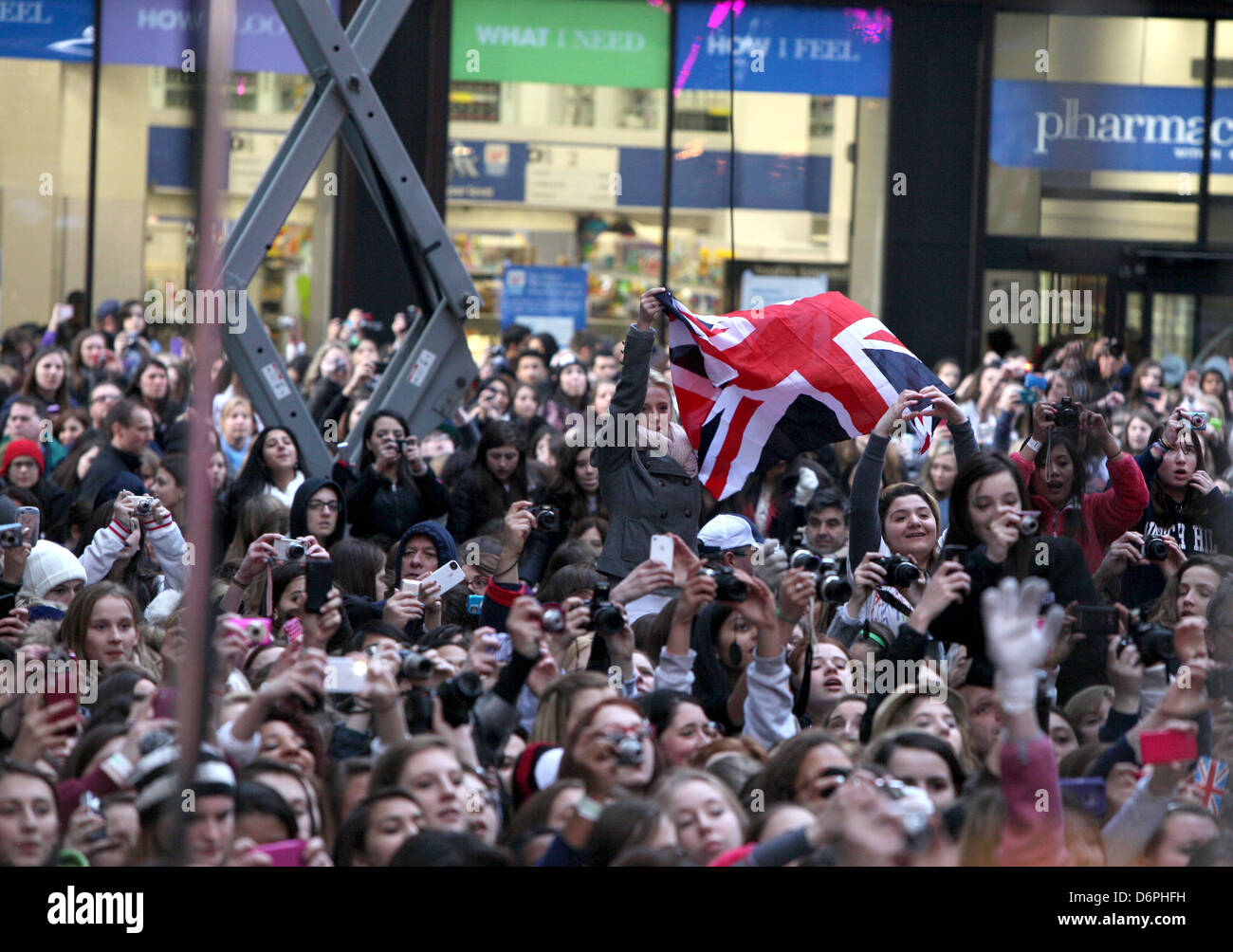 One Direction fans with a Union Jack flag One Direction performs on ...