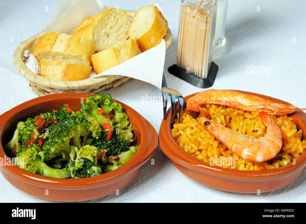 Tapas - Seafood and pork paella and broccoli with chilli and garlic. Stock Photo