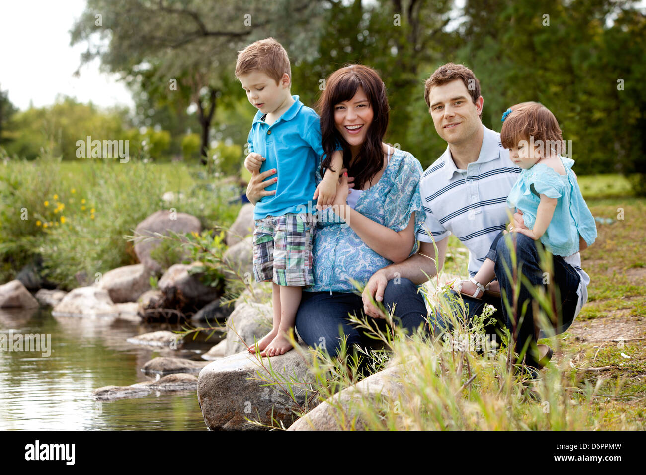 Family Near Lake in Park Stock Photo - Alamy