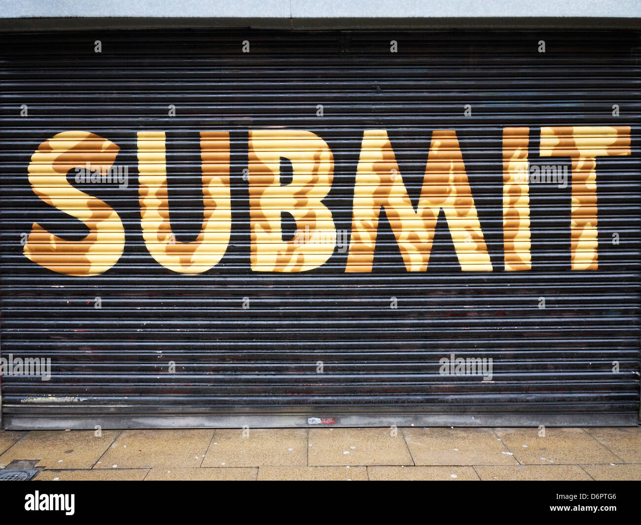Submit written on shutter in Manchester UK Stock Photo