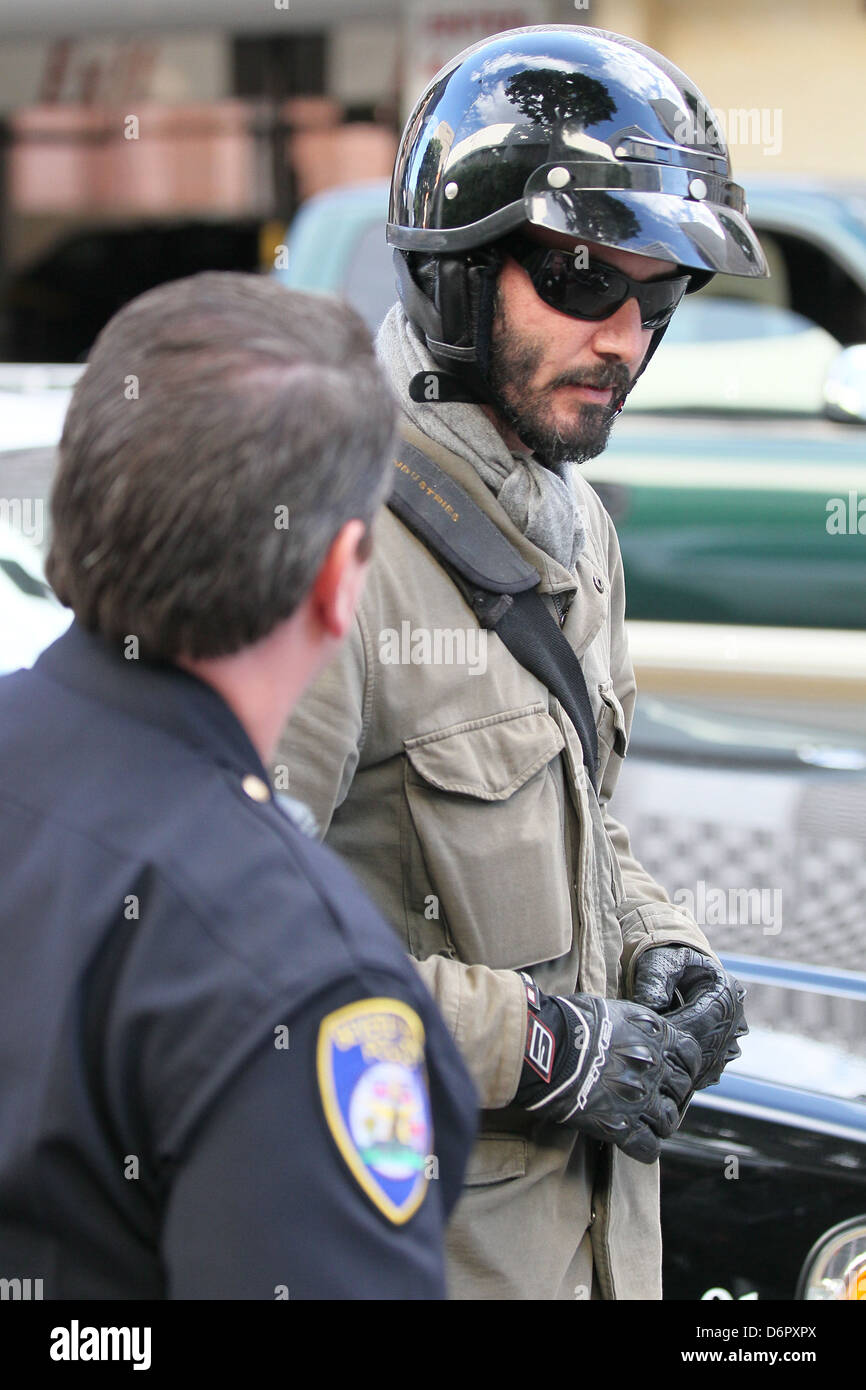 Keanu Reeves returning to the scene and speaking to the Beverly Hills Police  officer A woman parking on Roxbury Drive backed Stock Photo - Alamy