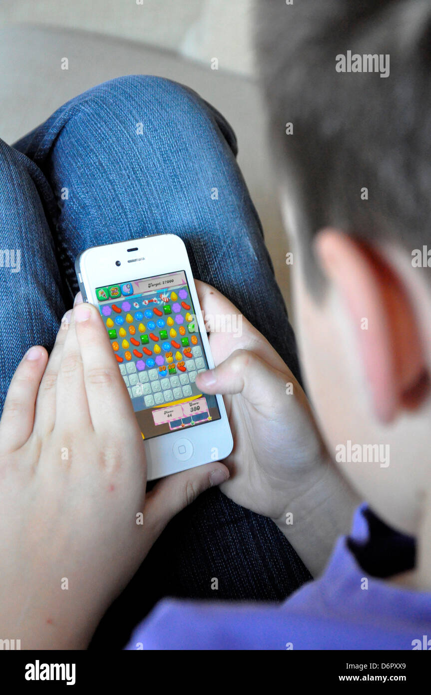 candy crush saga game iphone boy playing addicted winning concentrate game child Stock Photo