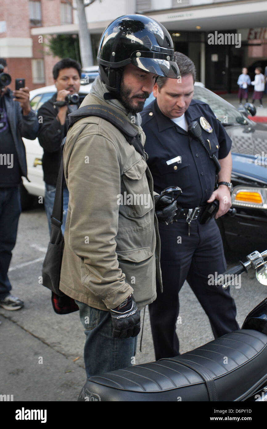 Keanu Reeves speaking with a Beverly Hills Police officer about the  accident A woman parking on Roxbury Drive backed her Stock Photo - Alamy