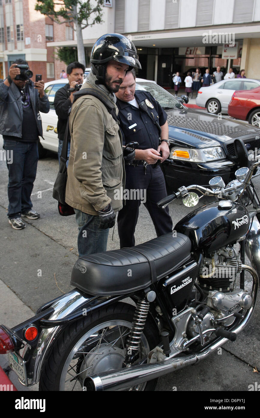 Keanu Reeves speaking with a Beverly Hills Police officer about the