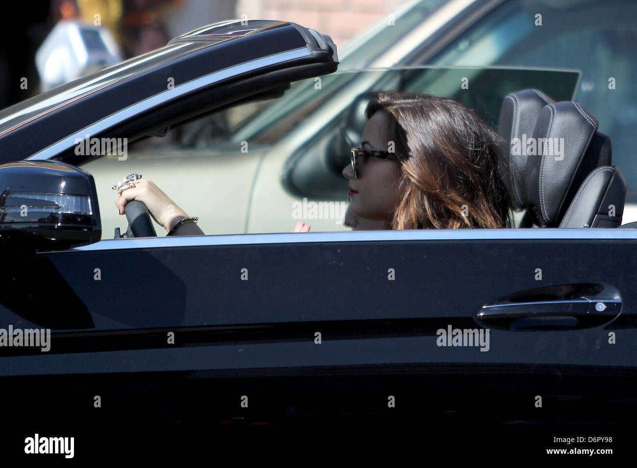 Demi Lovato driving in her black convertible after shopping at Slow  Boutique on Melrose Avenue Los Angeles, California Stock Photo - Alamy
