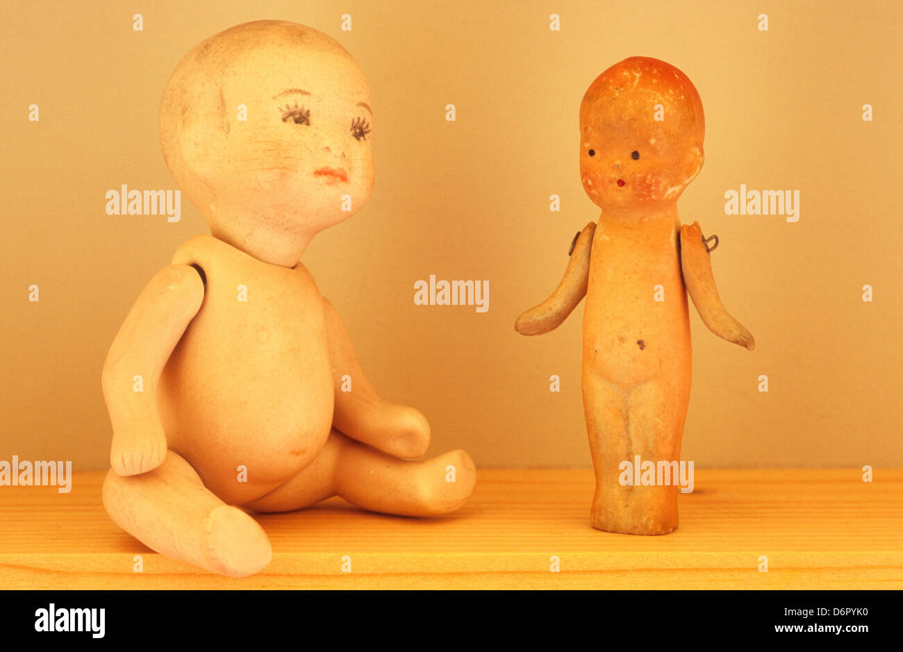 Close up of two naked traditional baby dolls from 1920s on wooden