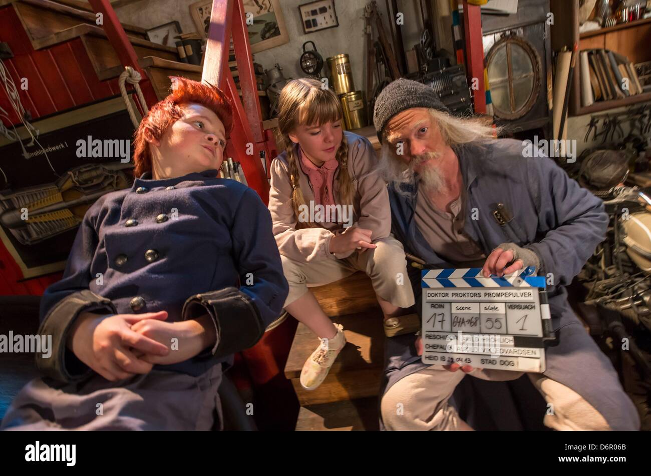 Actors ler Kristoffer Joner (Doktor Proktor, R), Emily Glaister (Lise, C) and Eilif H. Noraker (Bulle) sit on the movie set of the German-Norwegian co-production 'Dokto Proktors Pupspulver' (English translation Doctor Proctor's Fart Powder) in Erfurt, Germany, 22 April 2013. Jo Nesbos well-loved children's book about the crazy professor Doctor Proctor will be filmed in Erfurt until 07 May 2013 and then in Oslo, Norway. It should come to cinemas at the beginning of next year. Photo: MICHAEL REICHEL Stock Photo