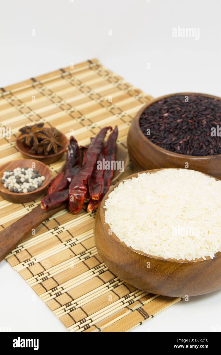 Jasmin rice and coarse rice in bowl with herb Stock Photo