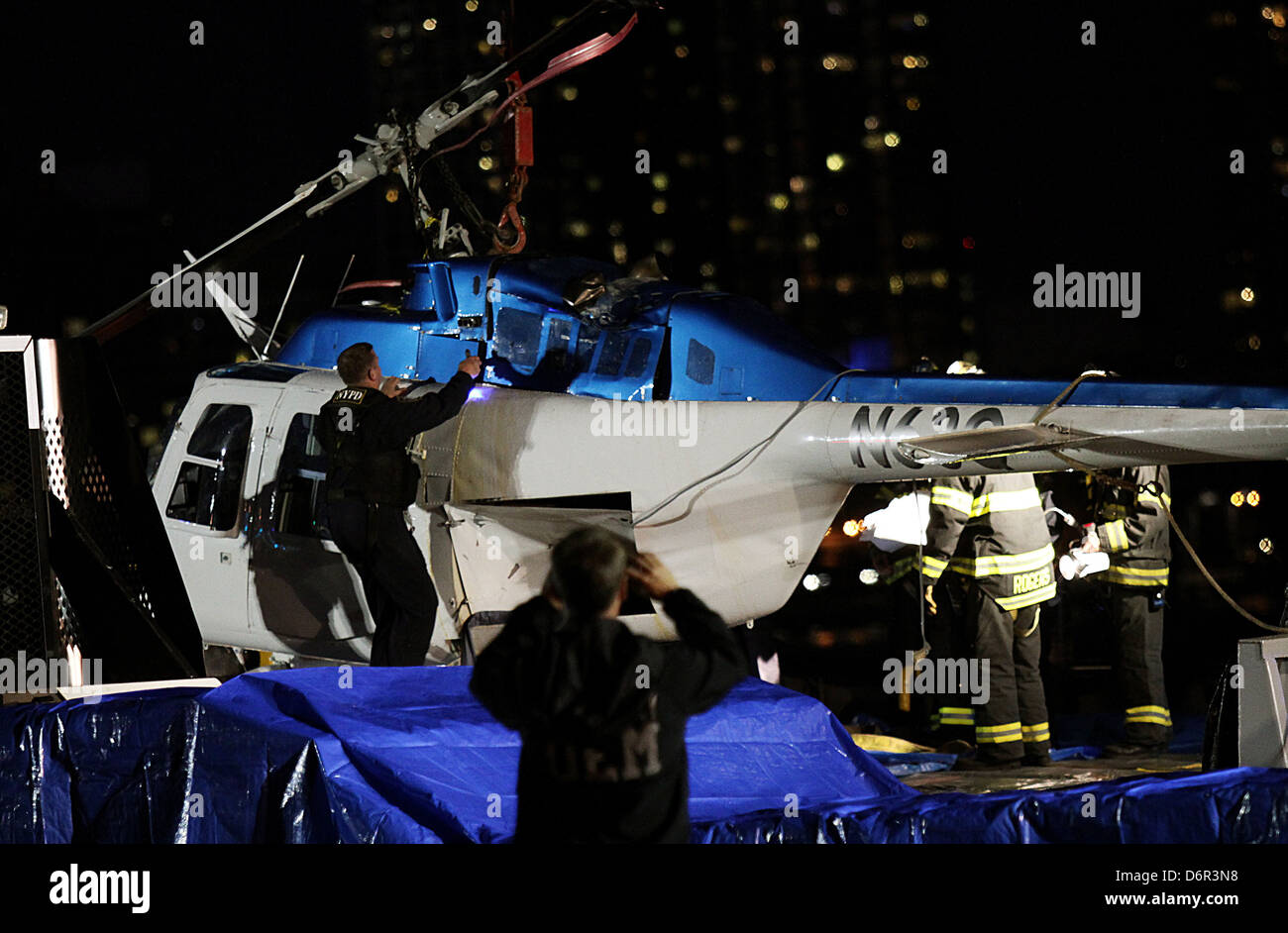 The helicopter being retrieved from the water A helicopter crashed in