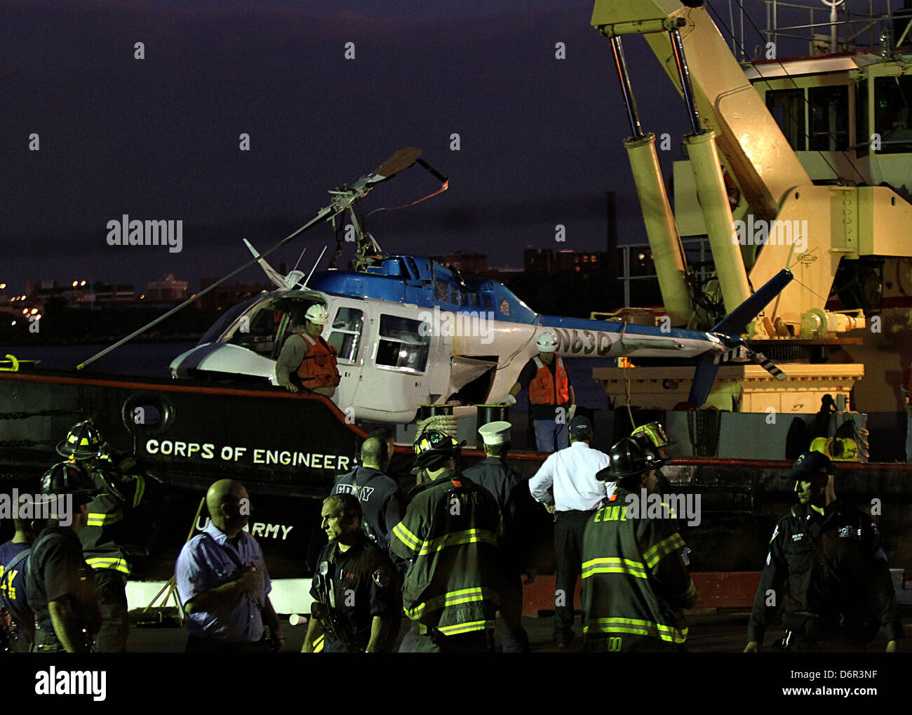 The helicopter being retrieved from the water A helicopter crashed in