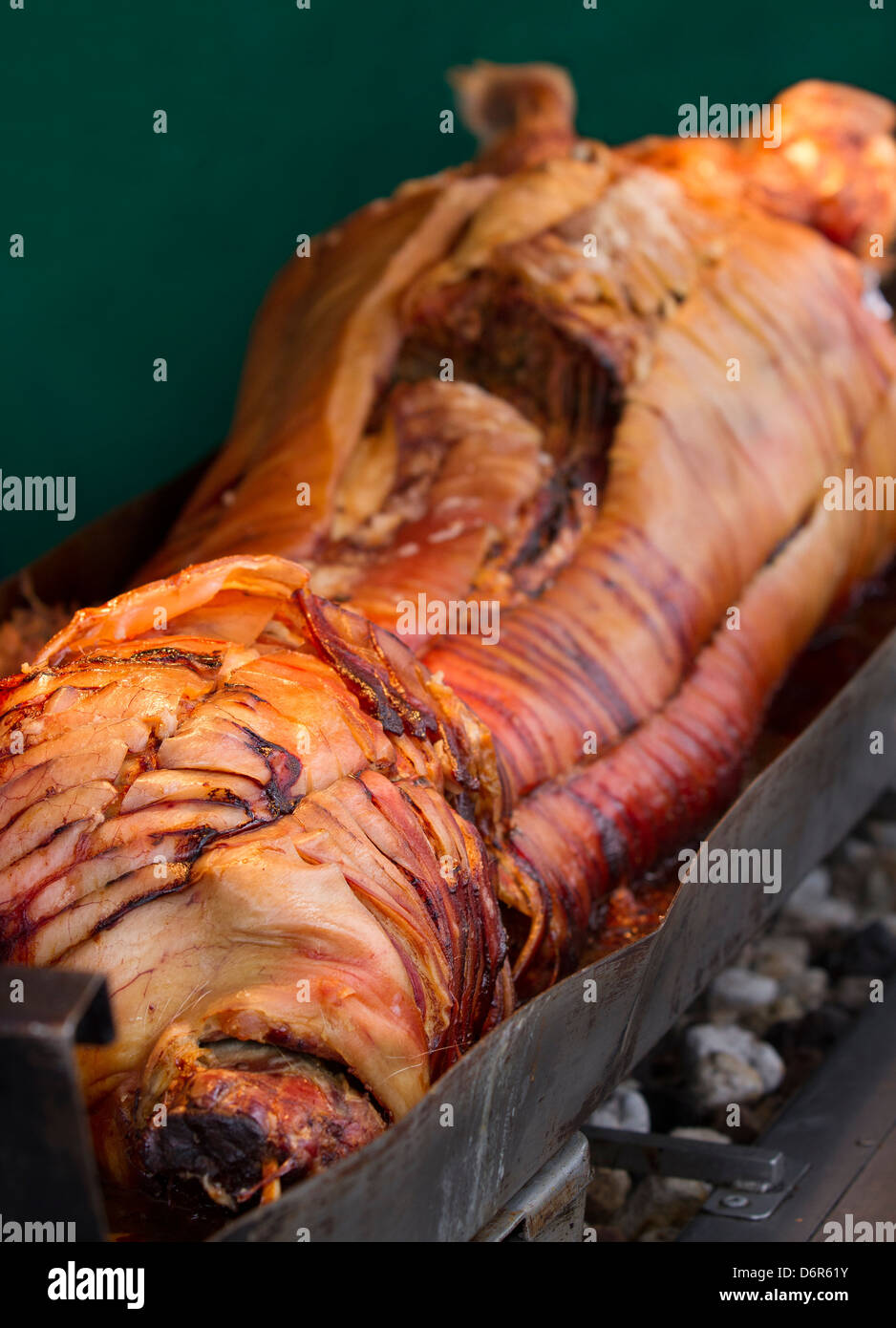 Barbecue of Roast pork. Roasting 'Pig Pickin' pig meats cooking on a rotisserie unit, Food Festival in Manchester, UK Stock Photo