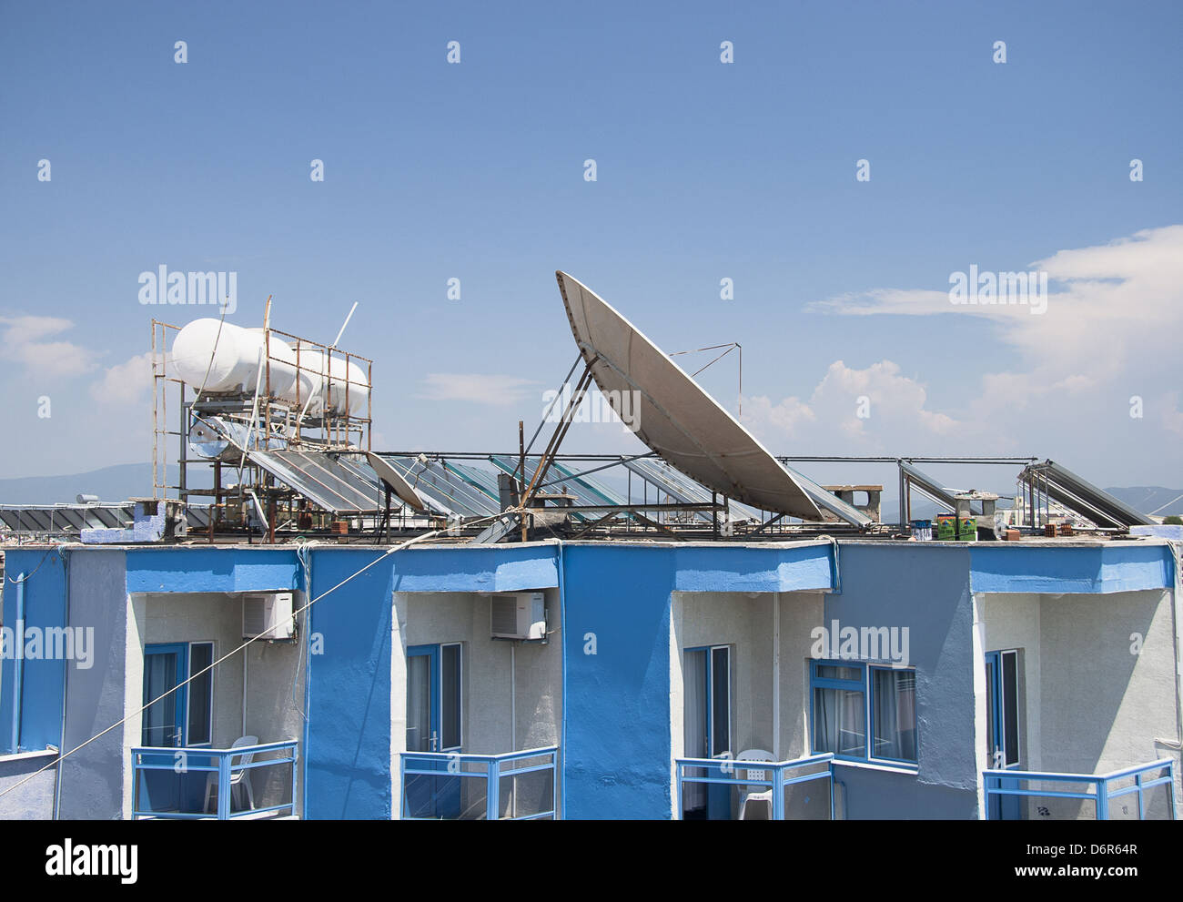 Satellite Dishes on the top of Roofs Stock Photo