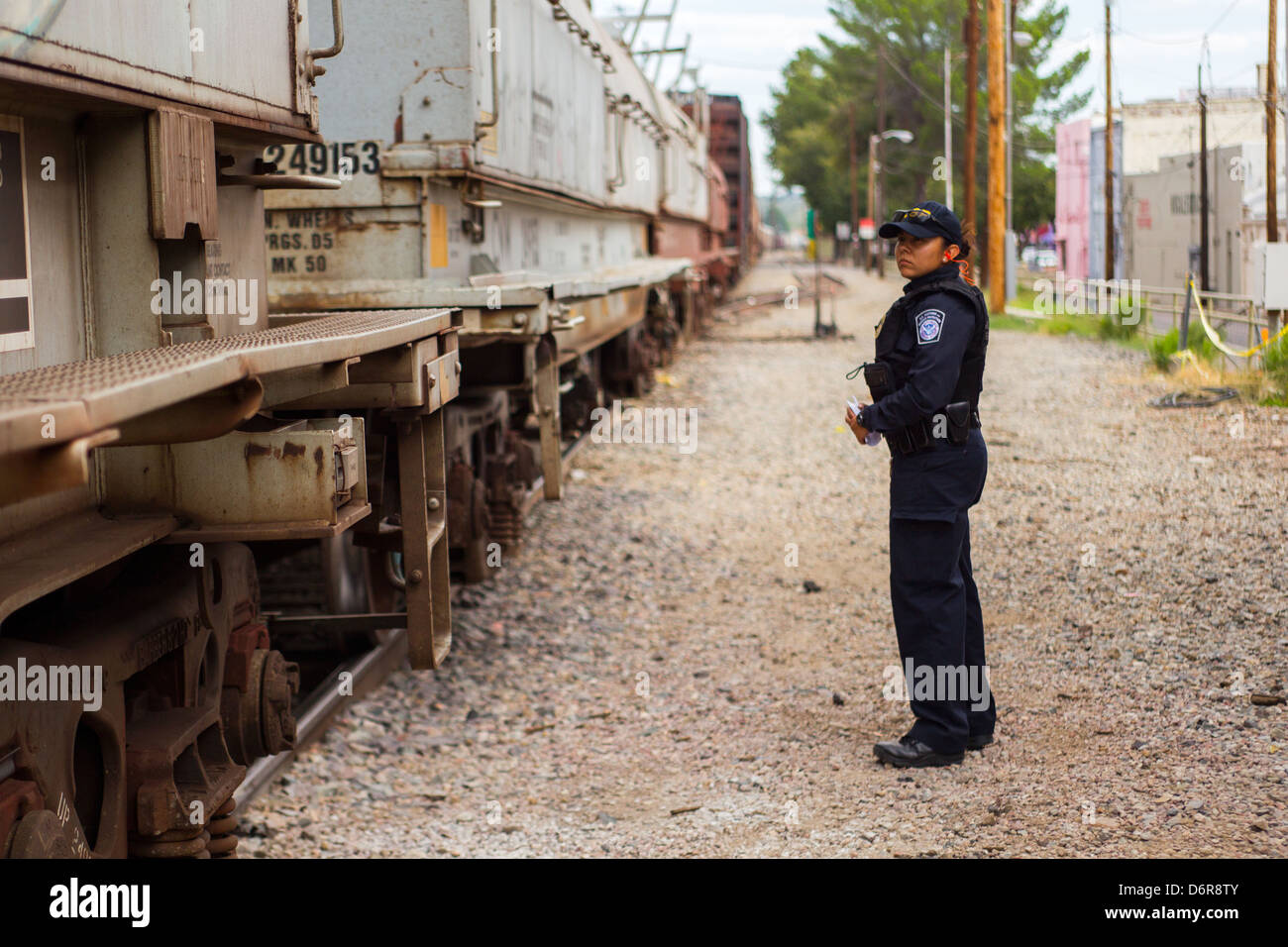 A US Customs and Border patrol officer checks a freight train crossing