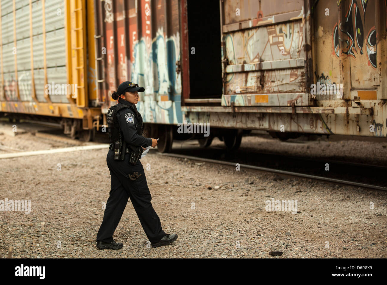A US Customs and Border patrol officer checks a freight train crossing
