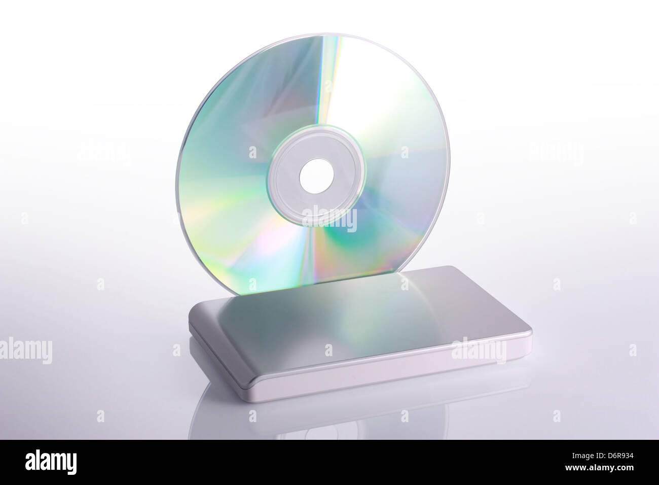 External hard disk and blank dvd on white background with reflection. Including clipping path. Stock Photo